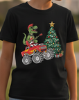 Child wearing a black t-shirt with a Christmas-themed graphic, standing outdoors.